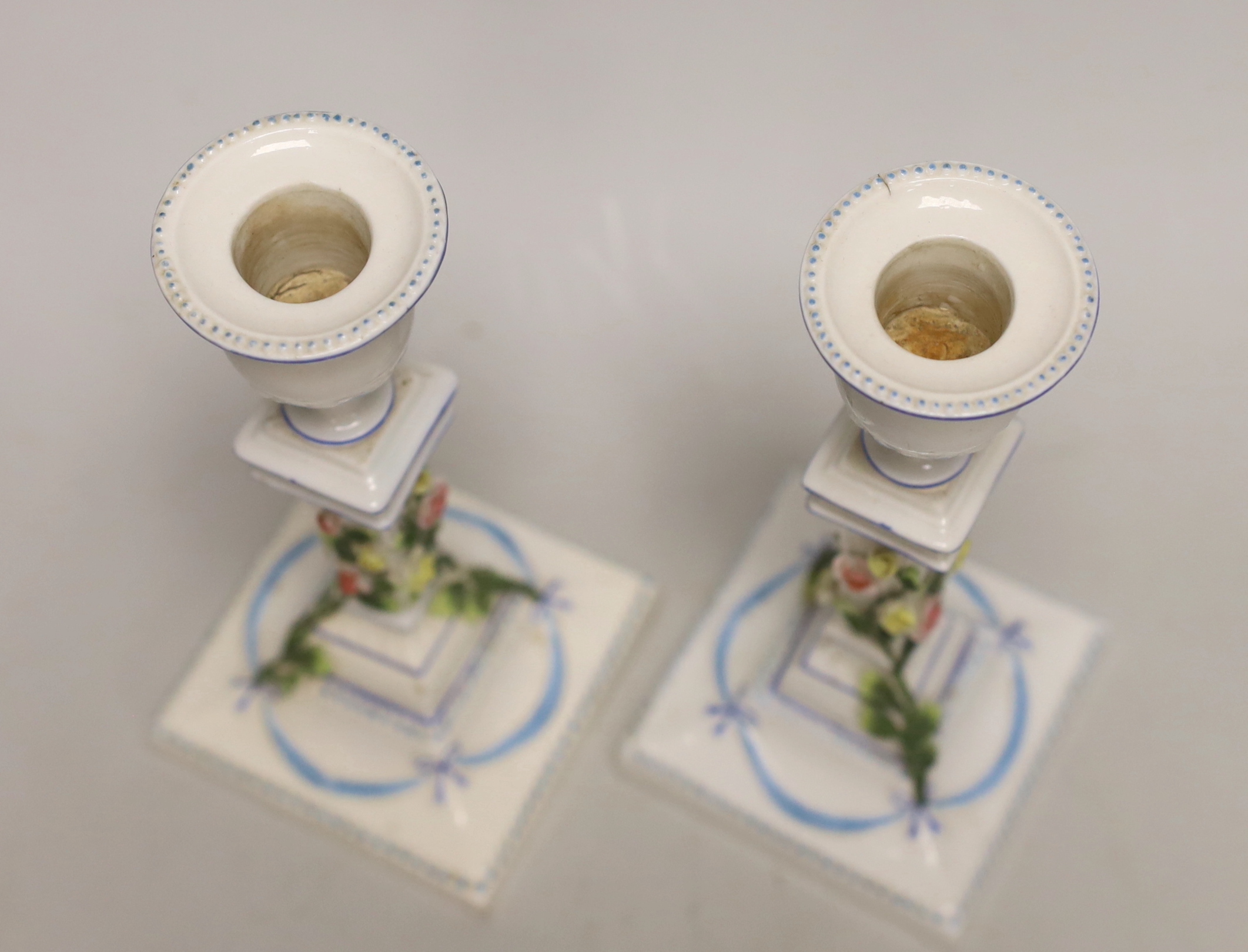 A pair of German porcelain candlesticks, marked JR, with applied floral decoration, 18cm